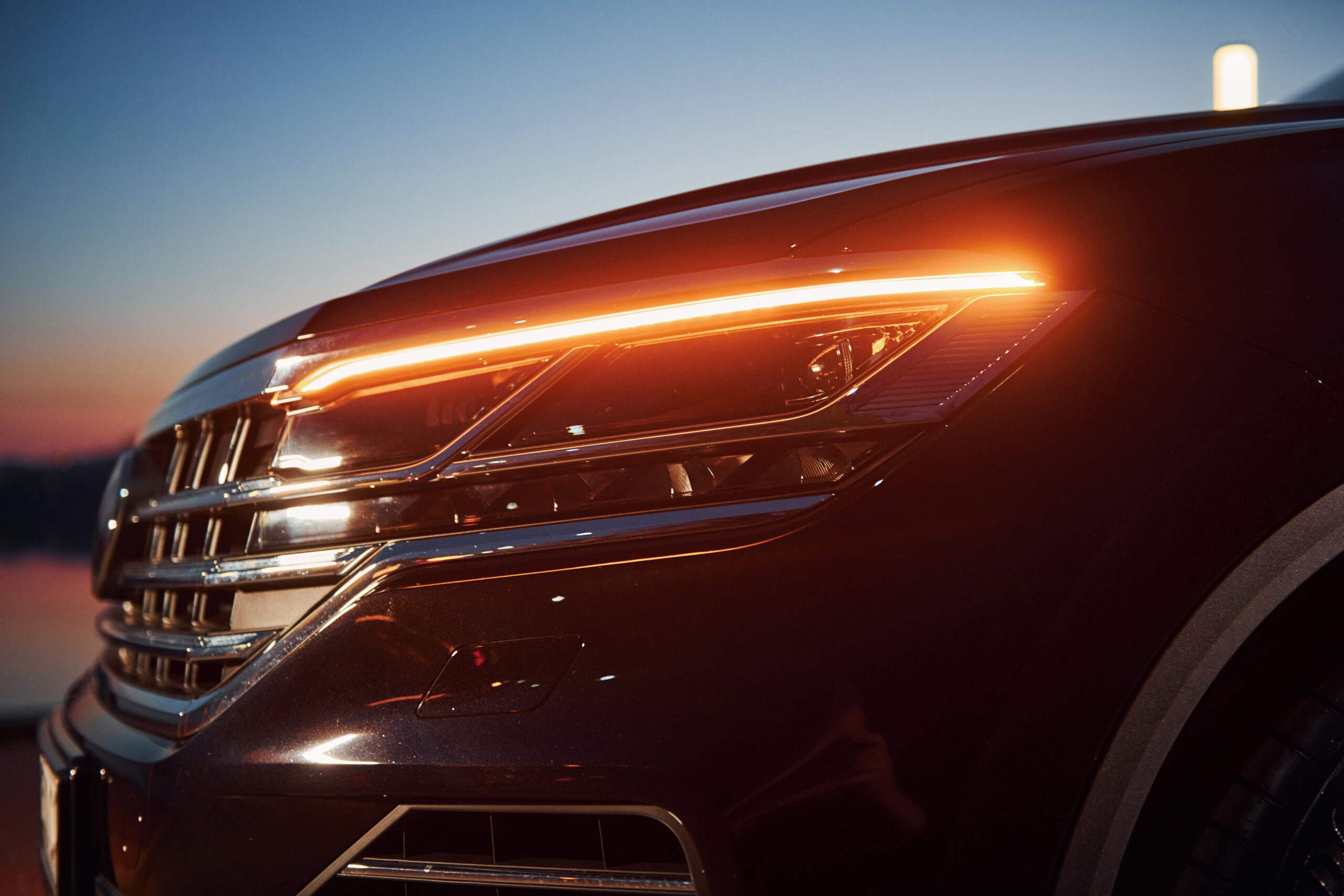 Close up particle view of of front part of modern new car parked outdoors.